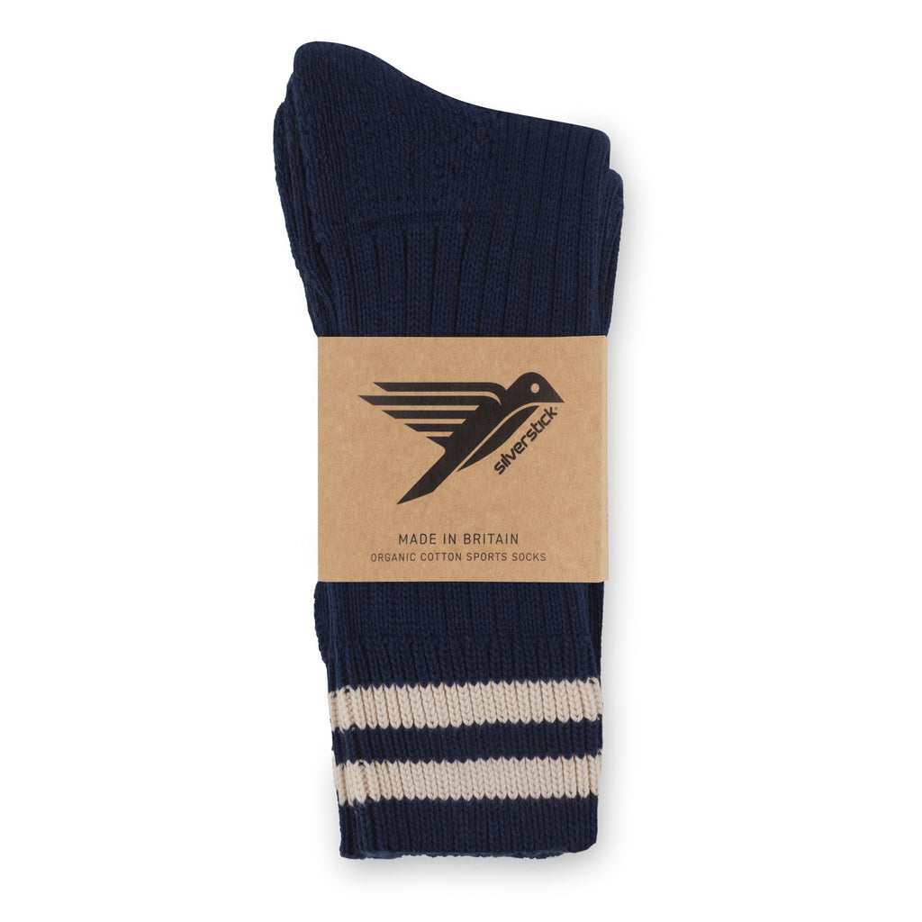 Navy blue sport sock with beige stripes and a visible brand label on a white background