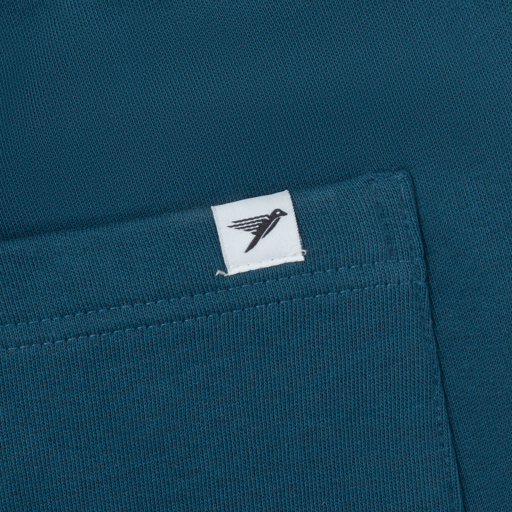 Close-up of a blue fabric with a white label featuring a logo.