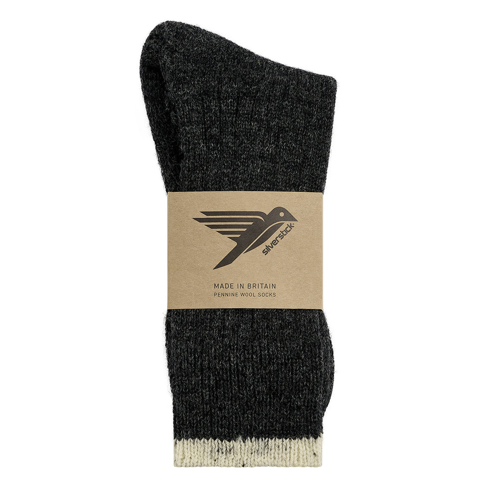 A single black knit sock with a beige cuff, wrapped in a brown paper band featuring the brand logo and 'Pennine Wool Socks' text, on a white background.