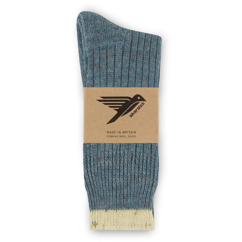 Blue sock with beige heel and toe, branded with a label on a white background
